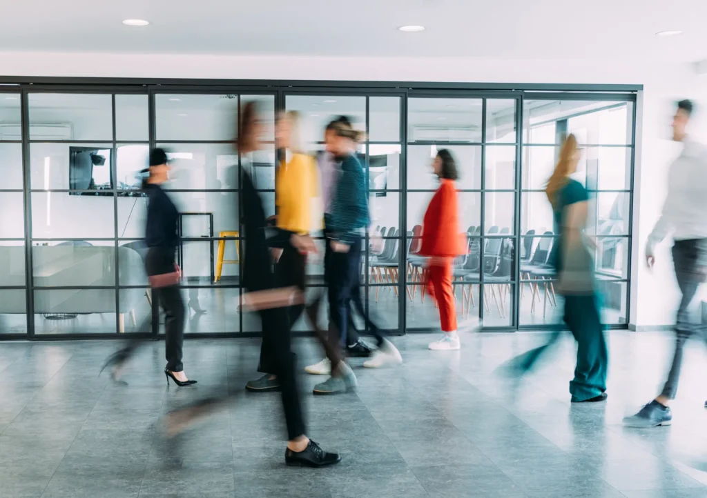 Walking People in Corporate Office Photo for Employee Benefits Service