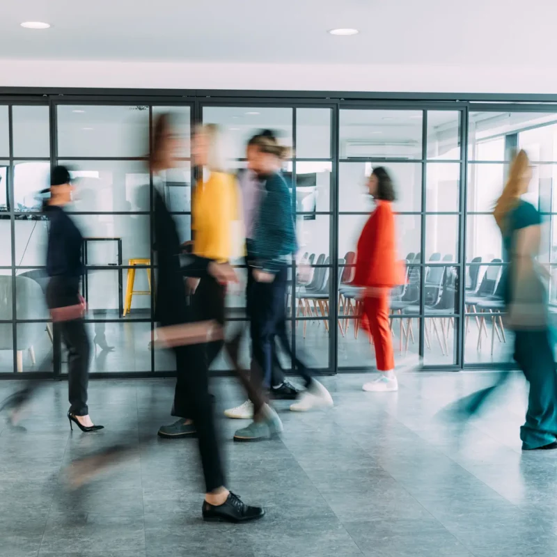 Walking People in Corporate Office Photo for Employee Benefits Service
